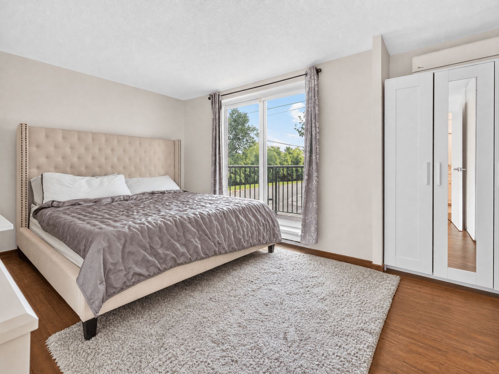 Primary bedroom with balcony door